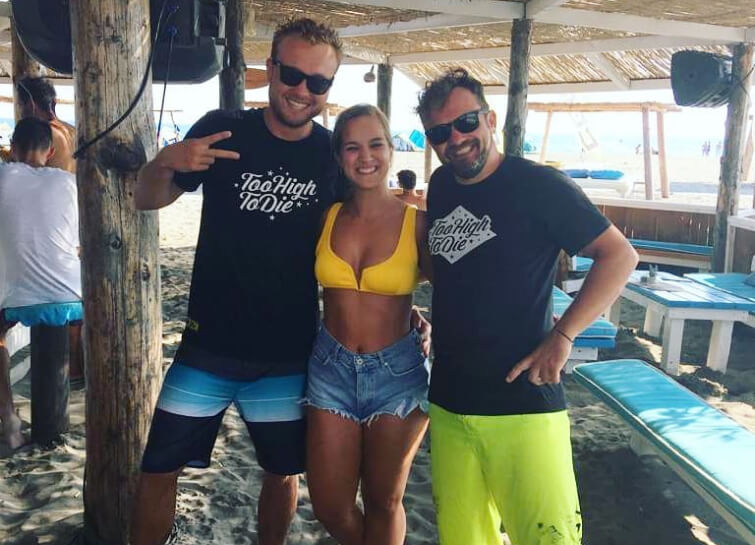 Friends in Too High To Die tees at a beach bar